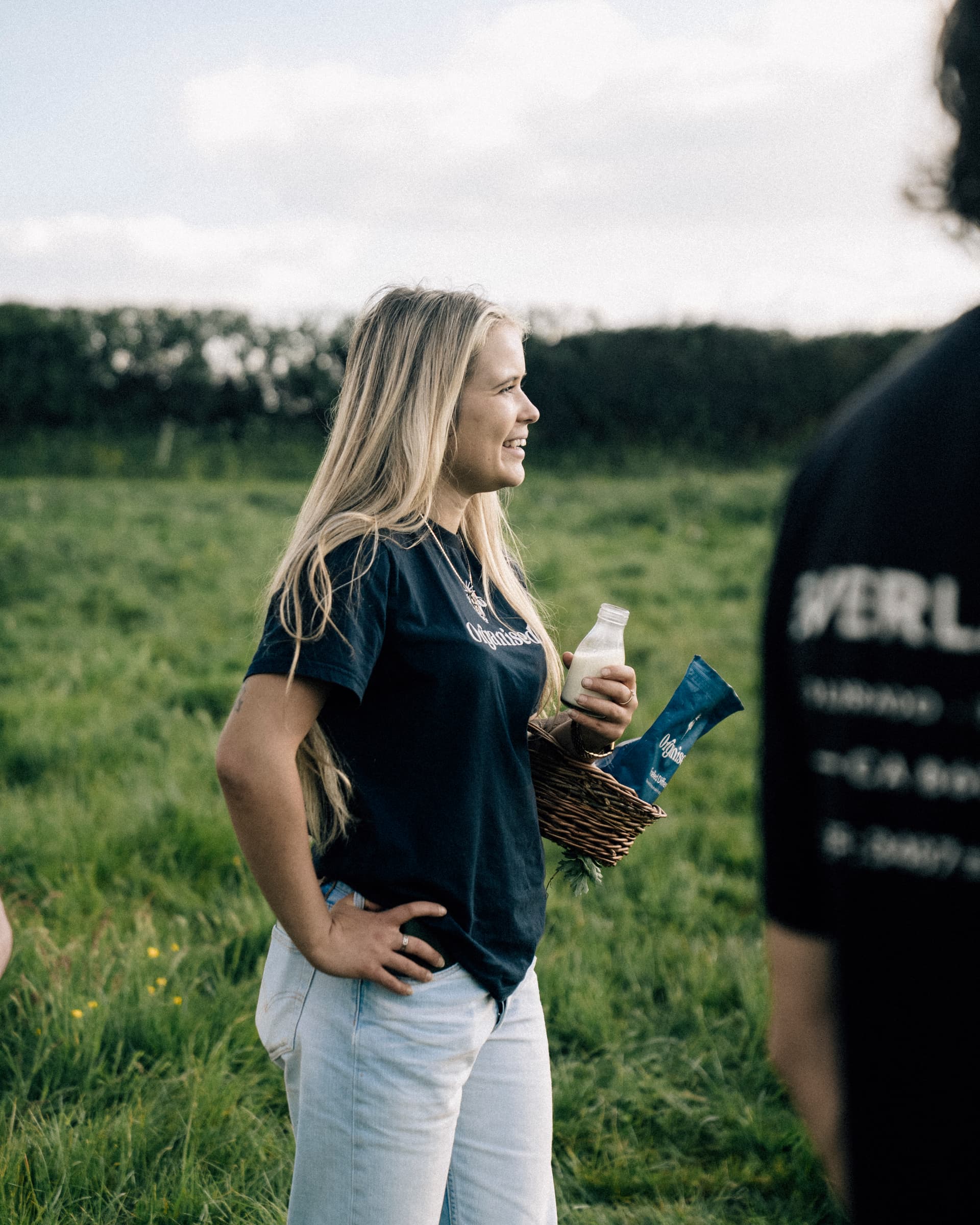 An Organised teammate in the field with a bottle of milk.