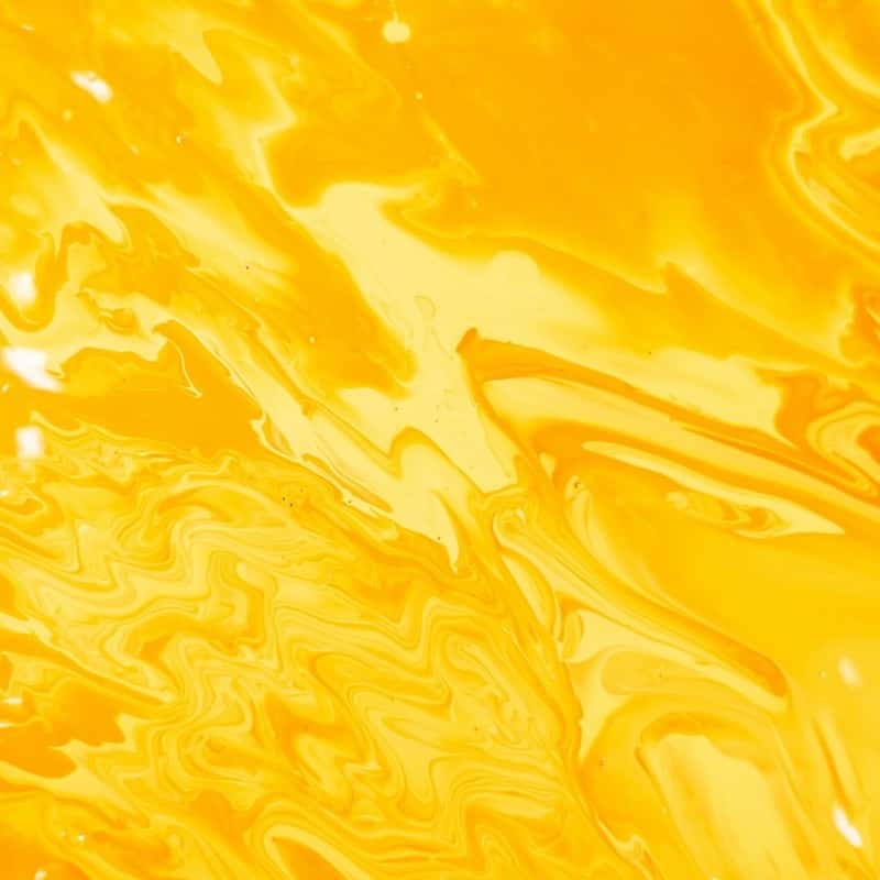 A swirl of golden yellow liquid, close up