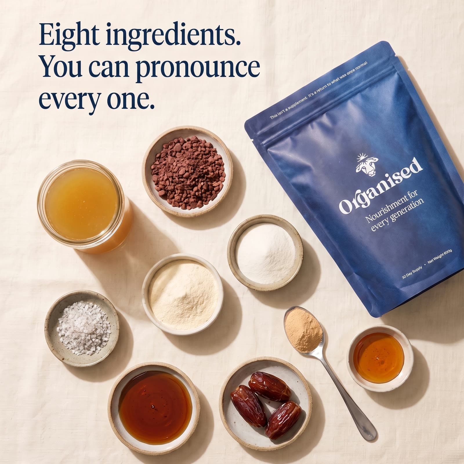 Eight ingredients. You can pronounce every one. The Organised pouch on linen beside bowls of the eight ingredients, dates and honey among them
